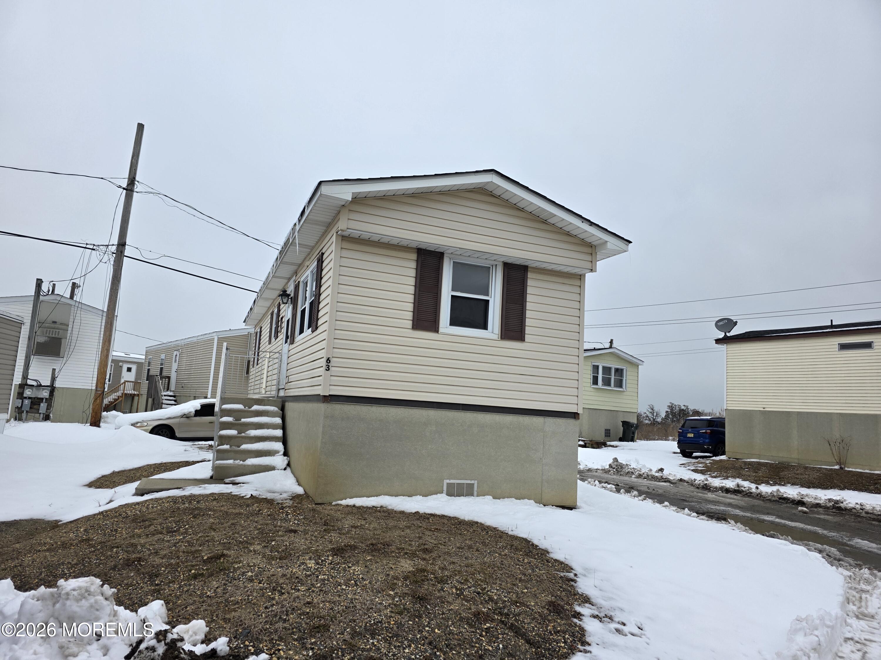 469 South Green Street, Unit 63 Tuckerton, NJ 08087 - Photo 2 of 11 a bedroom with a bed and a view of living room