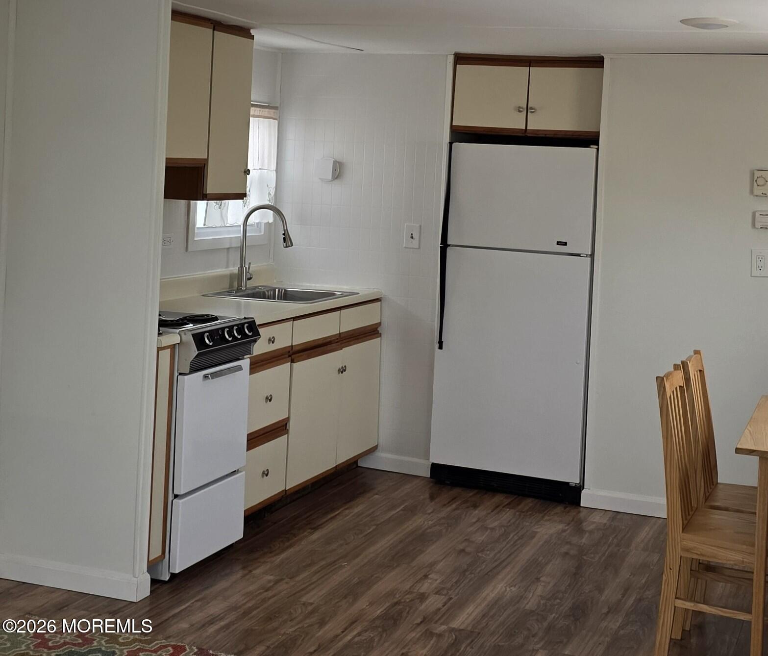 469 South Green Street, Unit 63 Tuckerton, NJ 08087 - Photo 4 of 11 a kitchen with sink a refrigerator and wooden floor