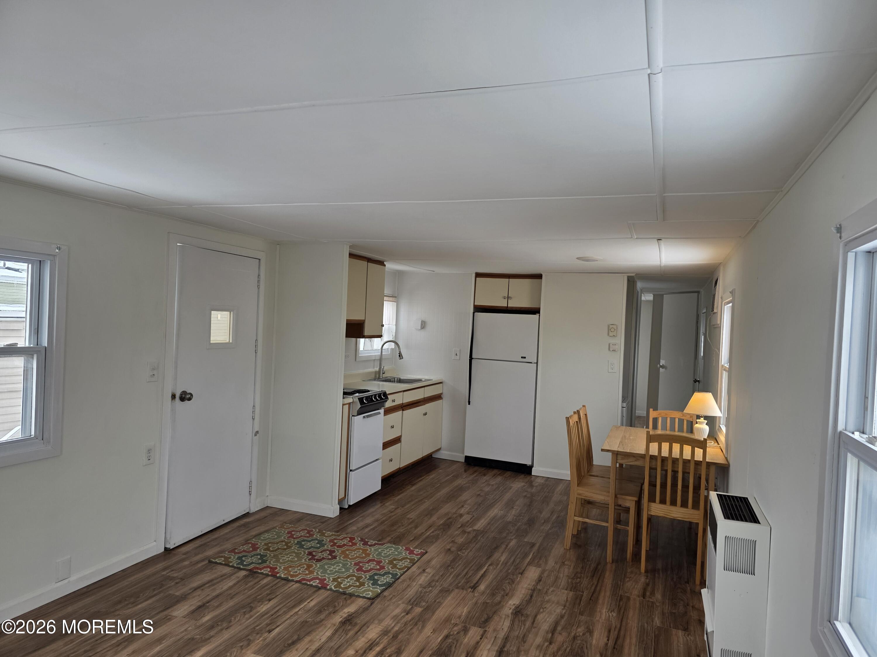 469 South Green Street, Unit 63 Tuckerton, NJ 08087 - Photo 5 of 11 a view of a kitchen with furniture and wooden floor