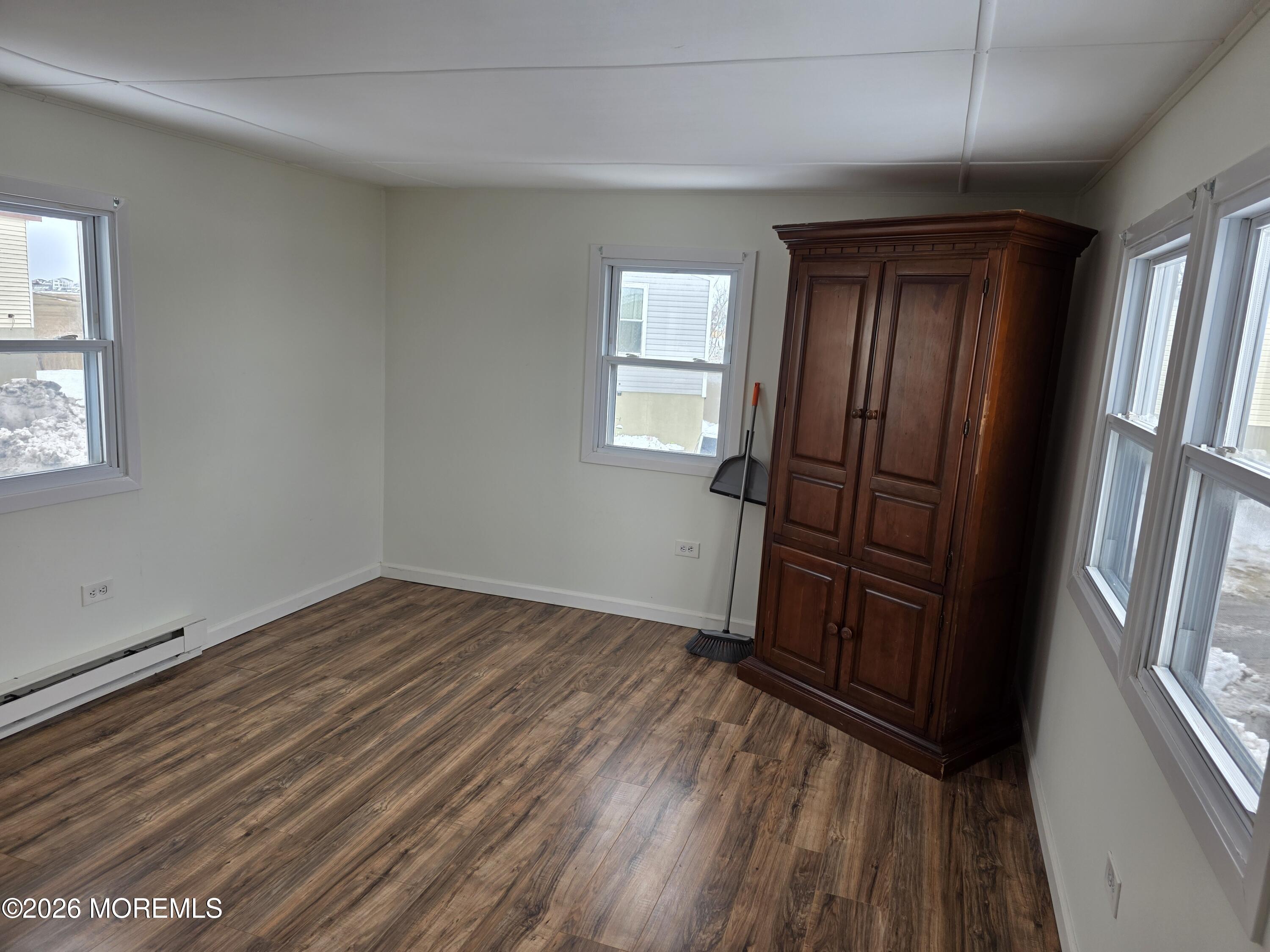 469 South Green Street, Unit 63 Tuckerton, NJ 08087 - Photo 6 of 11 an empty room with wooden floor and windows