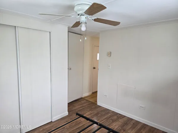 a view of an empty room and wooden floor