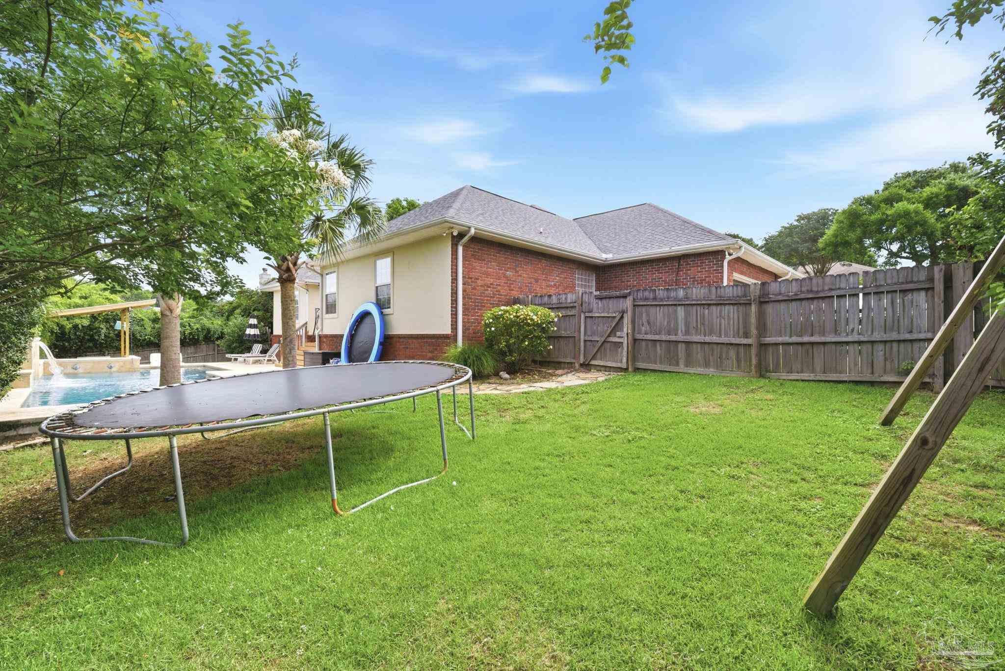 5931 Otter Point Road Pensacola, FL 32504 - Photo 46 of 67 a view of a backyard with a garden and entertaining space