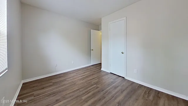 an empty room with wooden floor