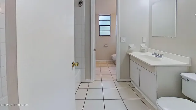 a bathroom with a sink a toilet and a shower