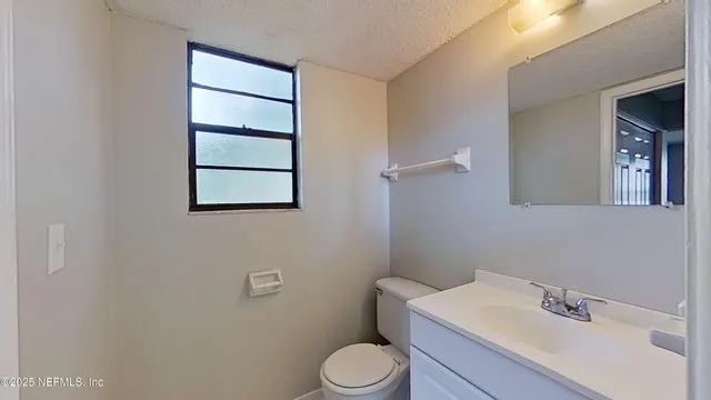 a bathroom with a sink toilet and vanity