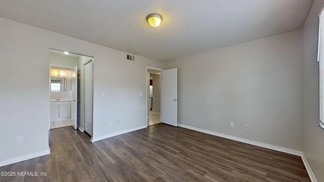 a view of a room with wooden floor