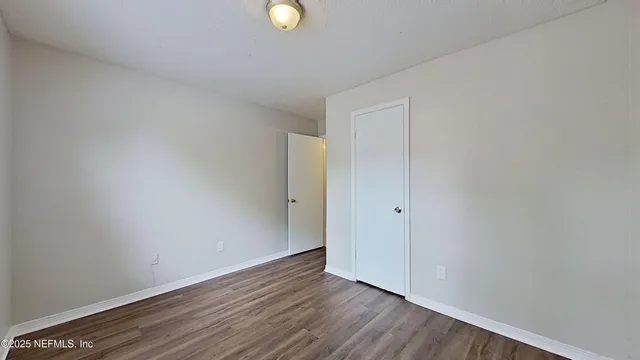 a view of an empty room and wooden floor