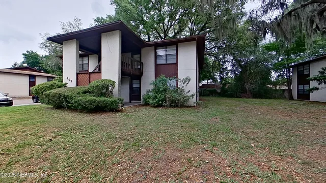 a front view of house with yard and trees