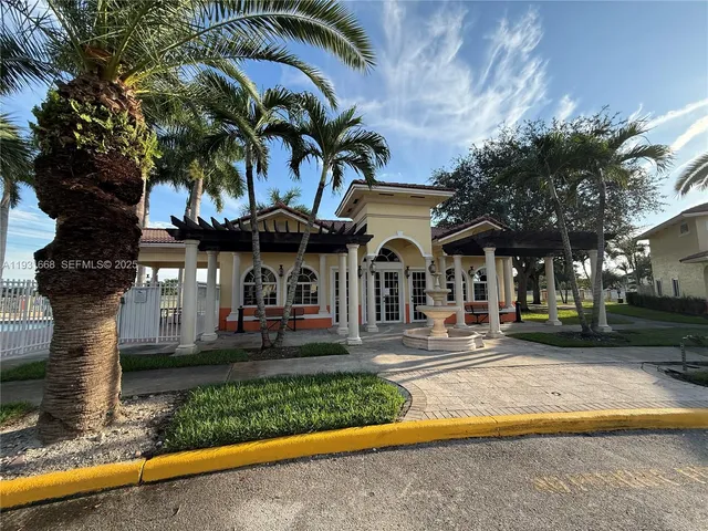 a front view of a house with swimming pool and porch with furniture