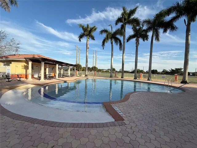 a view of swimming pool with outdoor seating