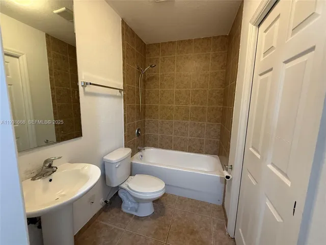 a bathroom with a toilet sink and bathtub