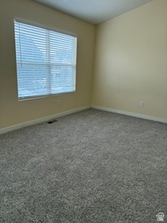 7936 Wycliffe Way Eagle Mountain, UT 84005 - Photo 30 of 37 Spacious interior room featuring textured gray carpeting, cream-colored walls, and white baseboards