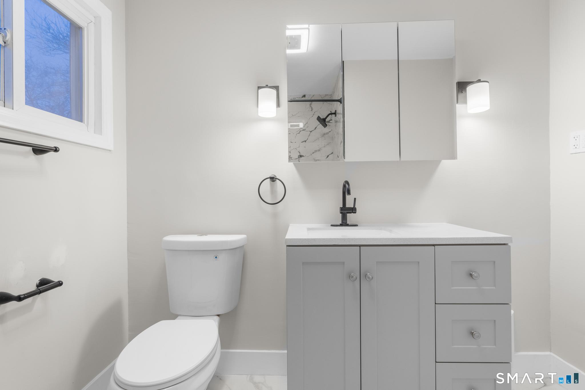 3 Highview Lane New Haven, CT 06513 - Photo 14 of 30 a white toilet sitting next to a bathroom sink