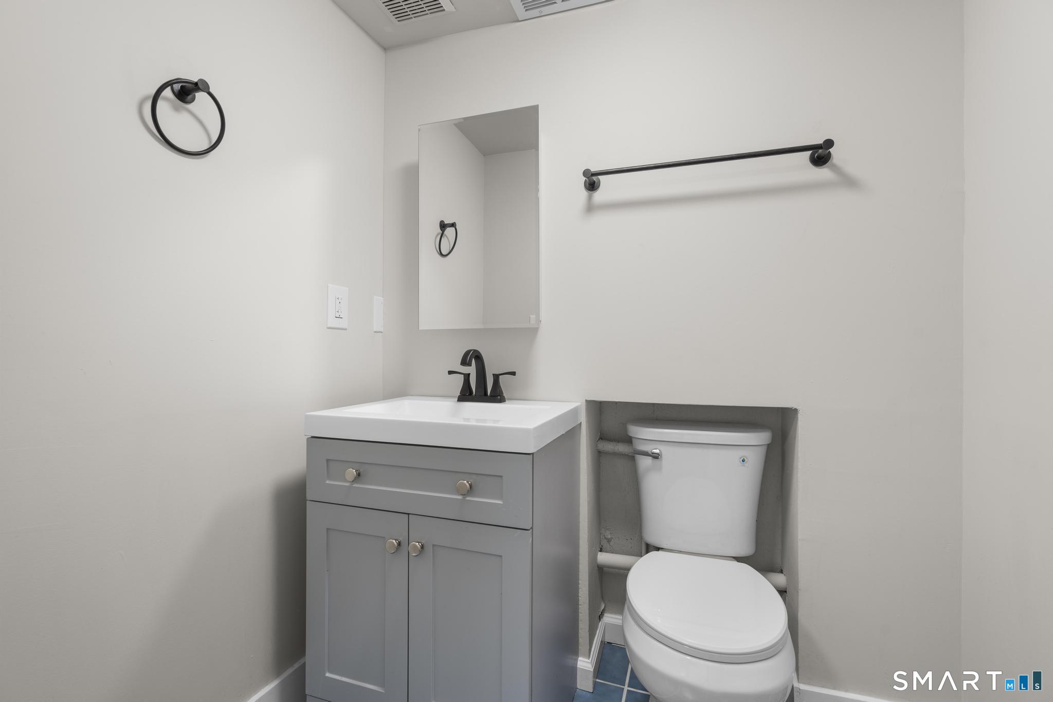 3 Highview Lane New Haven, CT 06513 - Photo 28 of 30 a bathroom with a toilet sink vanity and mirror