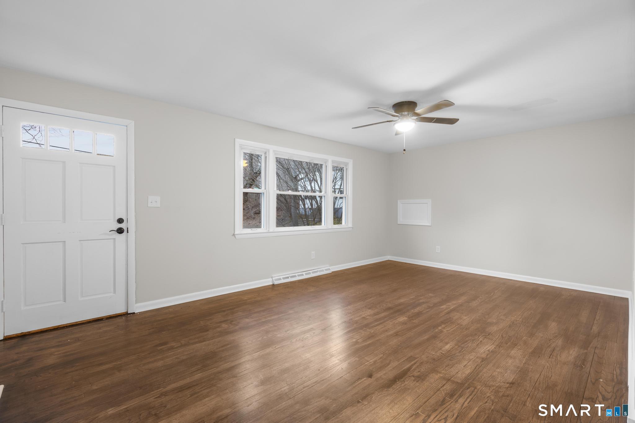 3 Highview Lane New Haven, CT 06513 - Photo 7 of 30 an empty room with wooden floor ceiling fan and windows
