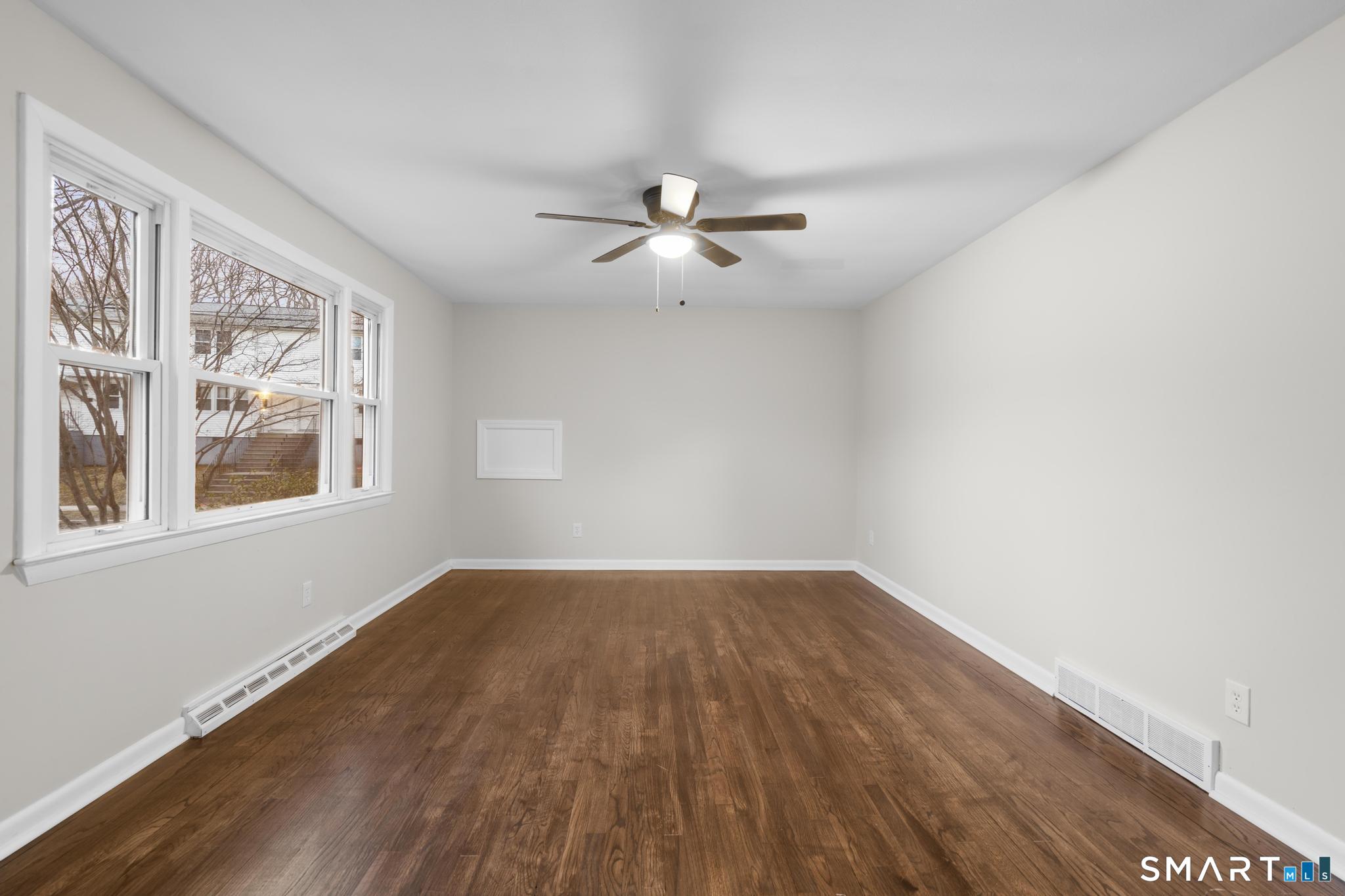 3 Highview Lane New Haven, CT 06513 - Photo 8 of 30 a view of empty room with wooden floor and fan