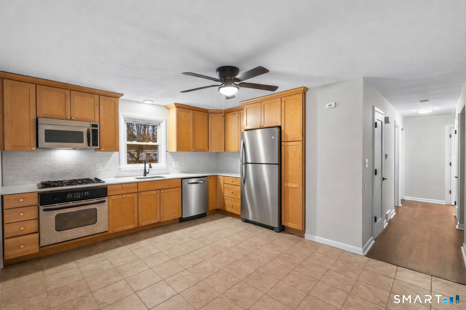 3 Highview Lane New Haven, CT 06513 - Photo 9 of 30 a kitchen with stainless steel appliances granite countertop a refrigerator a stove a sink a oven with a dining table and chairs