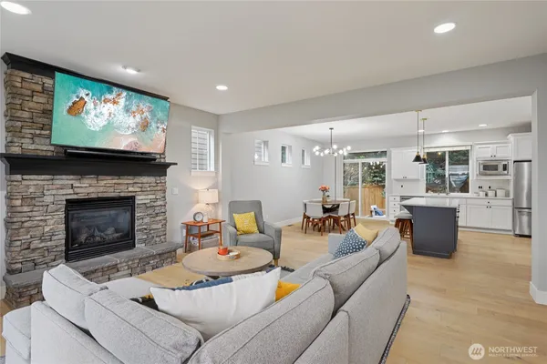 a living room with furniture a flat screen tv and a fireplace