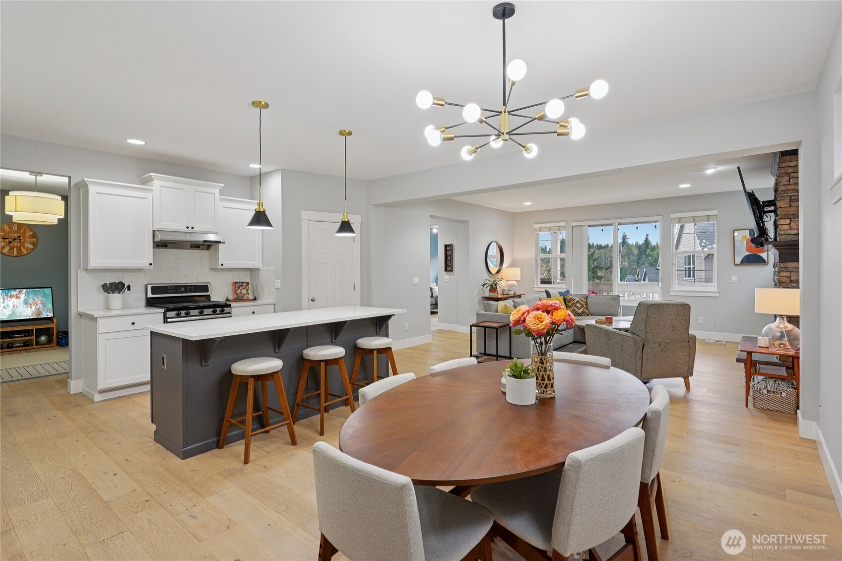 6523 128th Place Southwest Edmonds, WA 98026 - Photo 7 of 35 a kitchen with stainless steel appliances kitchen island granite countertop a table chairs and a refrigerator