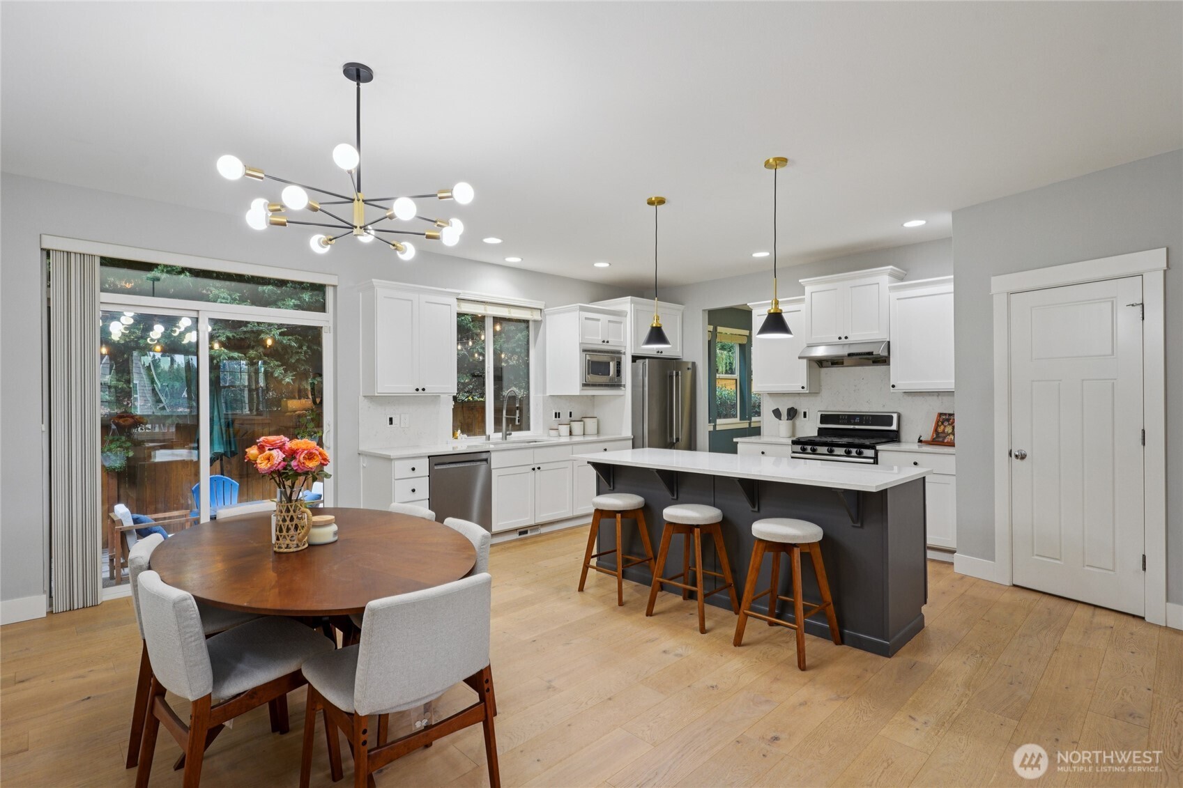 6523 128th Place Southwest Edmonds, WA 98026 - Photo 9 of 35 a kitchen with stainless steel appliances kitchen island granite countertop a dining table chairs and sink