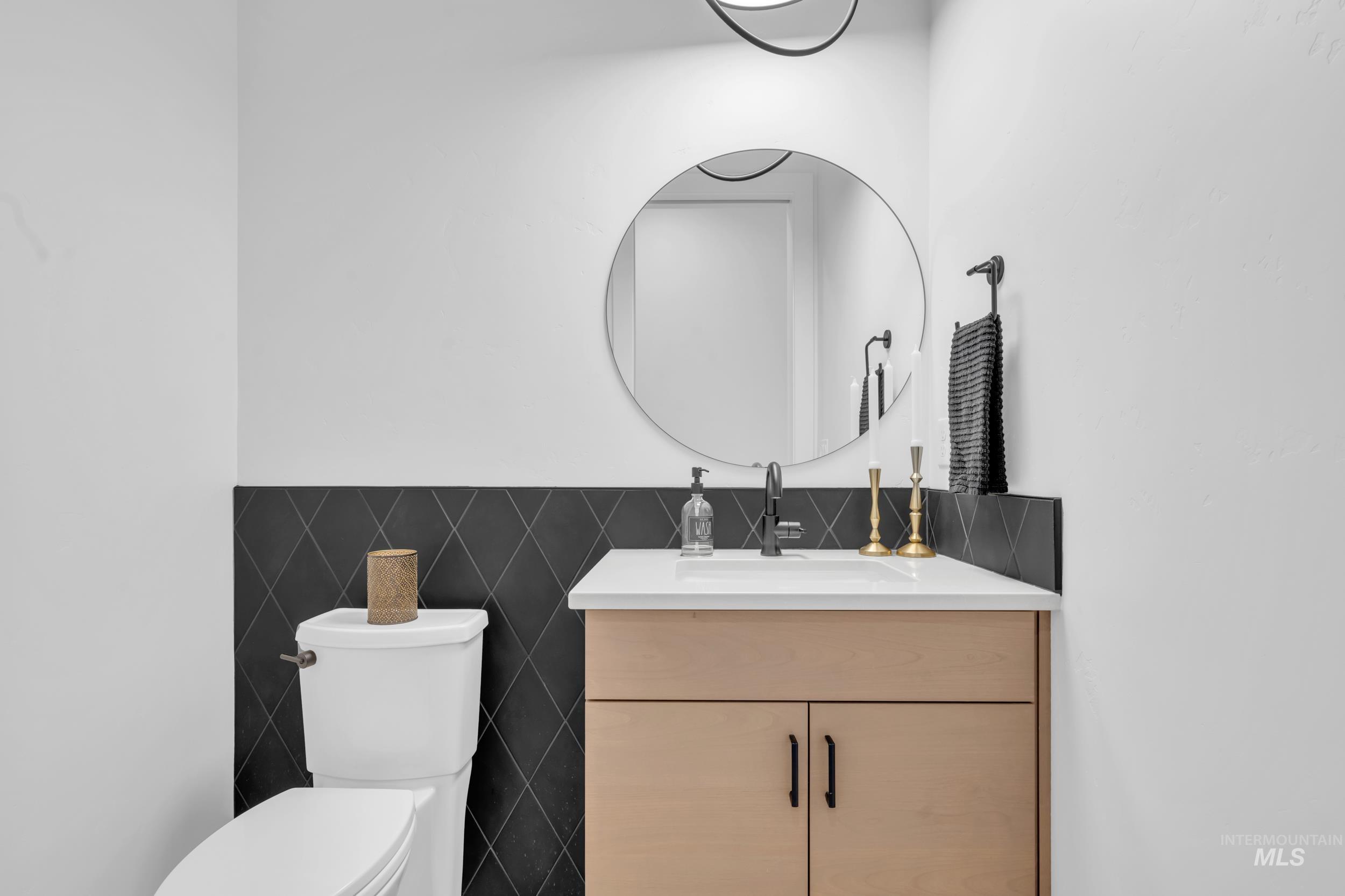 4447 East Copper Point Drive Meridian, ID 83642 - Photo 27 of 41 Bathroom with vanity and tile walls