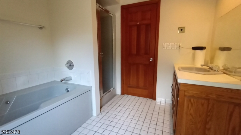 83 Lakeside Drive Vernon, NJ 07461 - Photo 11 of 34 a bathroom with a tub shower and sink
