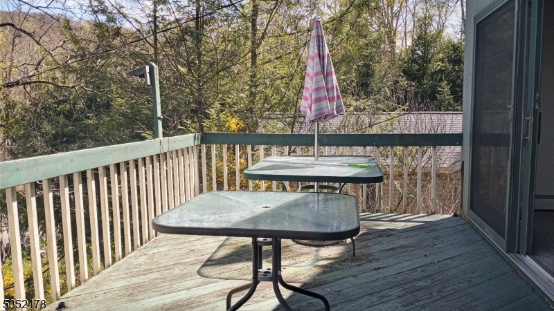 83 Lakeside Drive Vernon, NJ 07461 - Photo 24 of 34 a view of a balcony with a table and chairs