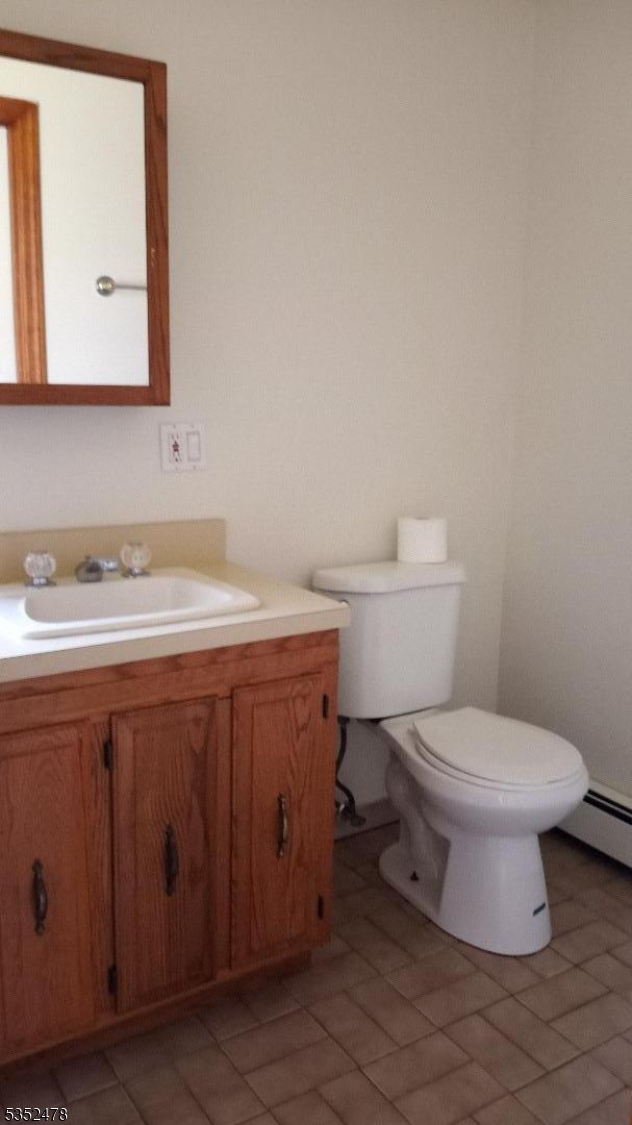 83 Lakeside Drive Vernon, NJ 07461 - Photo 25 of 34 a bathroom with a toilet sink and mirror