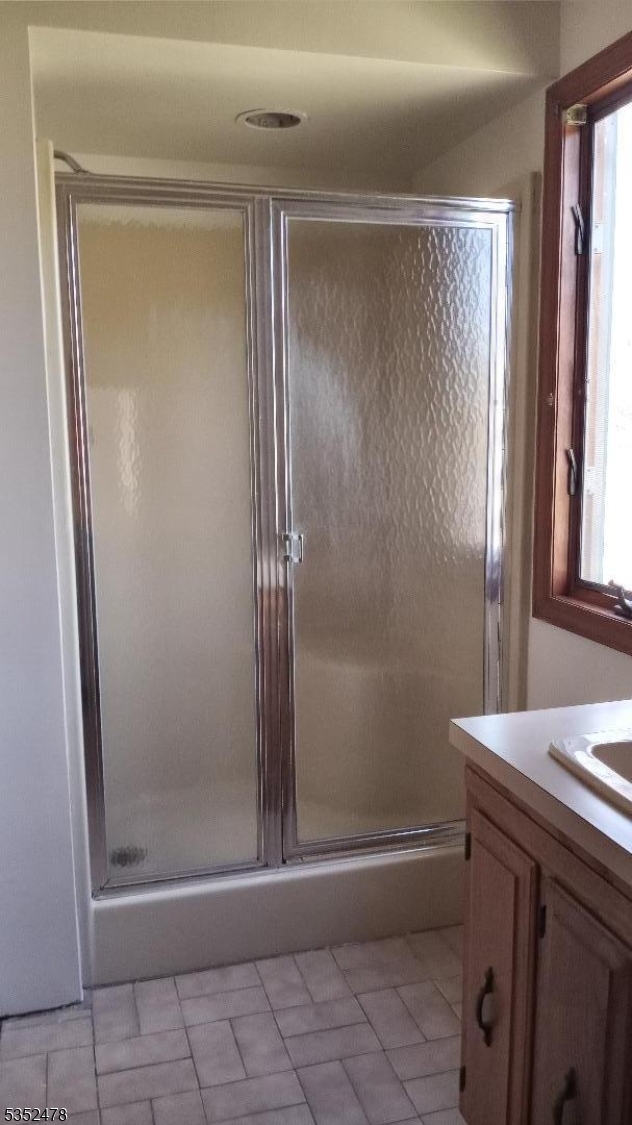 83 Lakeside Drive Vernon, NJ 07461 - Photo 26 of 34 a bathroom with a glass shower door