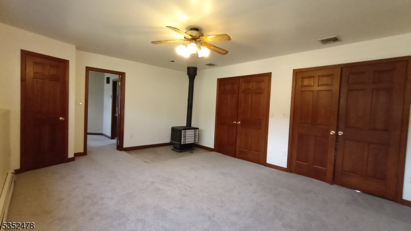 83 Lakeside Drive Vernon, NJ 07461 - Photo 10 of 34 an empty room with closet and a chandelier fan