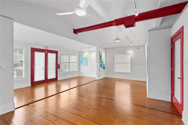 a view of a hallway with wooden floor and a fireplace