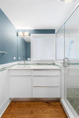 a bathroom with a shower and a sink