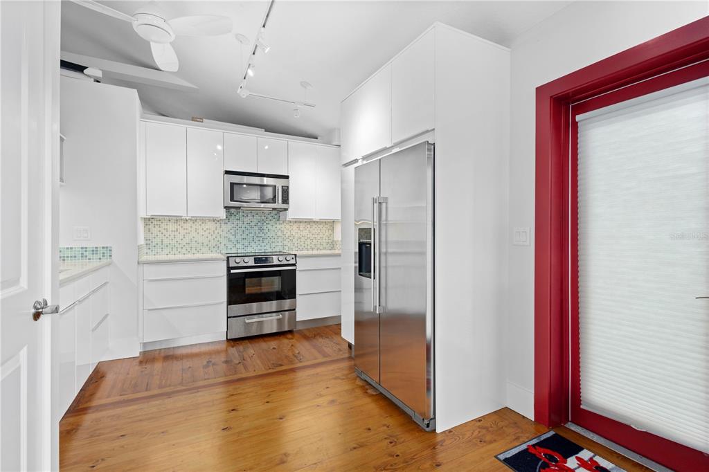 1950 Adams Lane Sarasota, FL 34236 - Photo 8 of 18 a kitchen with stainless steel appliances a refrigerator and a stove top oven