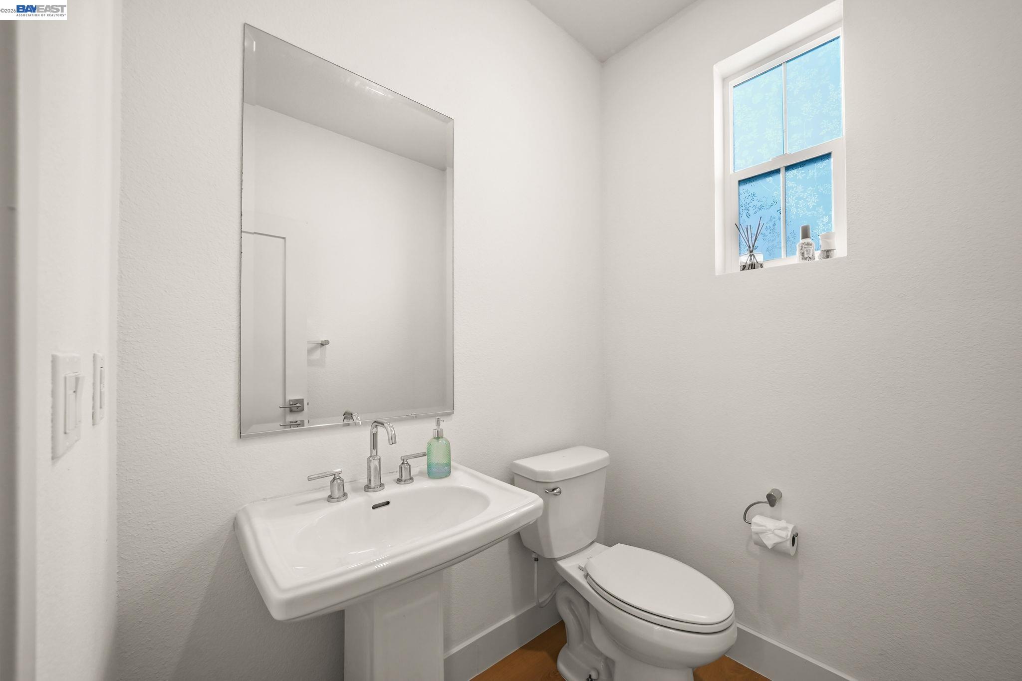 9034 Rudder Way Newark, CA 94560 - Photo 12 of 42 a bathroom with a toilet a sink and mirror