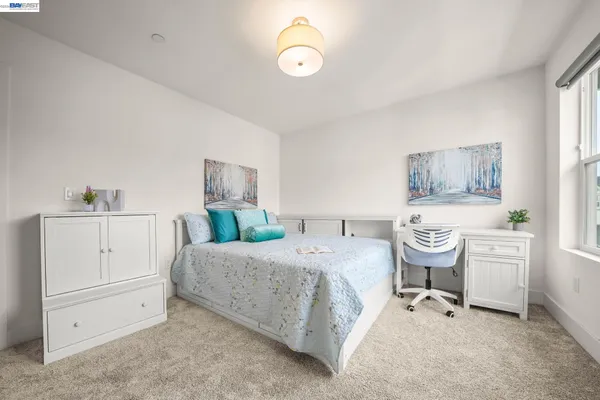 a spacious bedroom with a bed and a cabinets