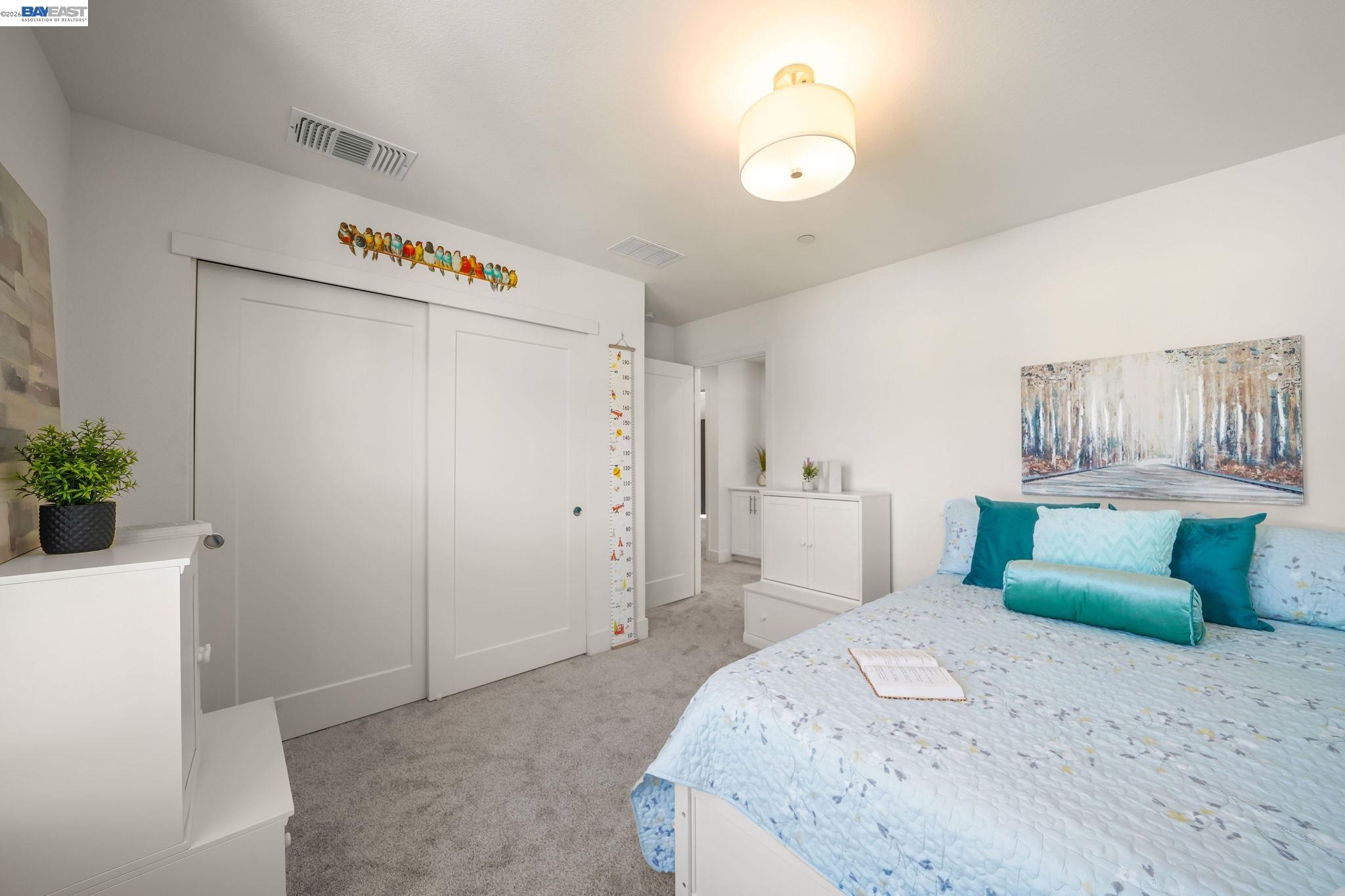 9034 Rudder Way Newark, CA 94560 - Photo 17 of 42 a bedroom with a bed and a chandelier