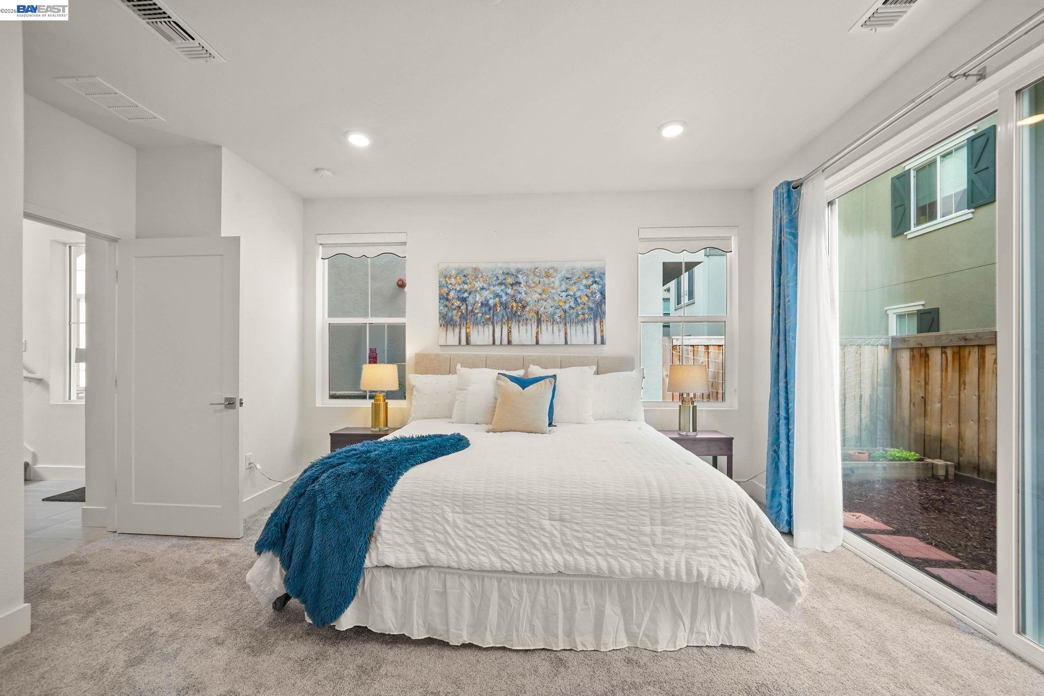 9034 Rudder Way Newark, CA 94560 - Photo 26 of 42 a bedroom with a large bed and a chandelier