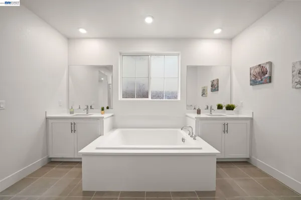 a bathroom with a sink a mirror and a bathtub