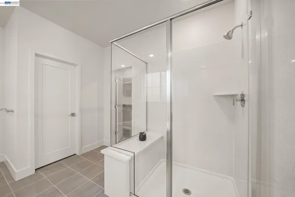 a bathroom with a shower and a glass door