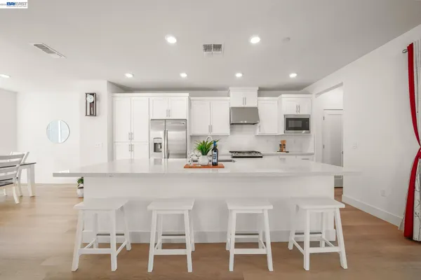 a kitchen with stainless steel appliances kitchen island granite countertop a sink and cabinets
