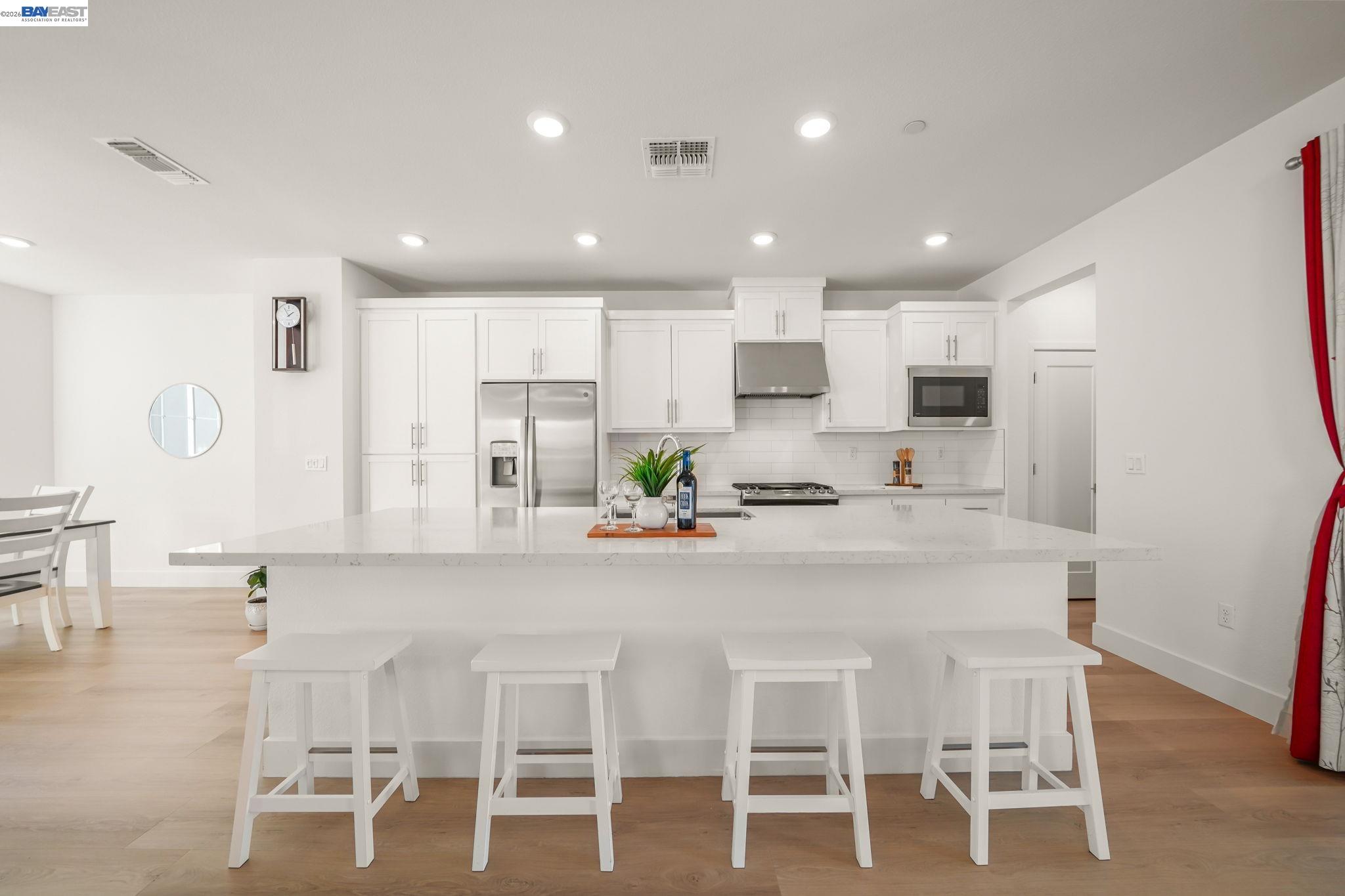 9034 Rudder Way Newark, CA 94560 - Photo 8 of 42 a kitchen with stainless steel appliances kitchen island granite countertop a sink and cabinets