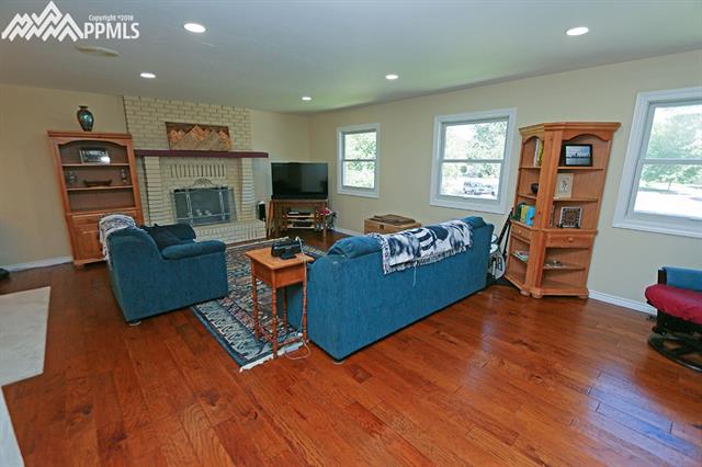 3123 Springdowns Place Colorado Springs, CO 80906 - Photo 7 of 36 Large main level living room with natural light and updated windows.