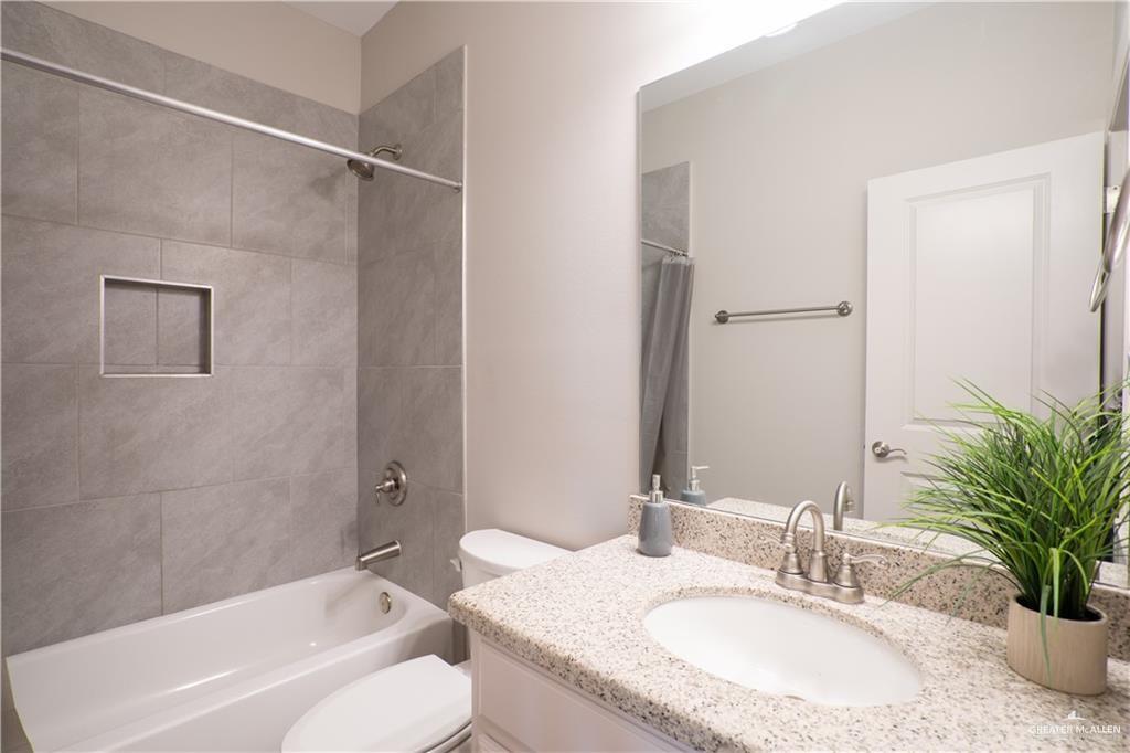 14117 Boykin Creek Road McAllen, TX 78504 - Photo 12 of 19 a bathroom with a granite countertop sink toilet and shower