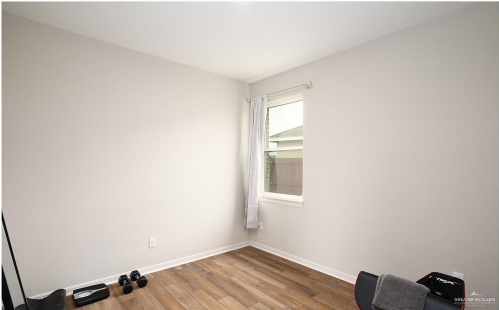 14117 Boykin Creek Road McAllen, TX 78504 - Photo 14 of 19 wooden floor in an empty room