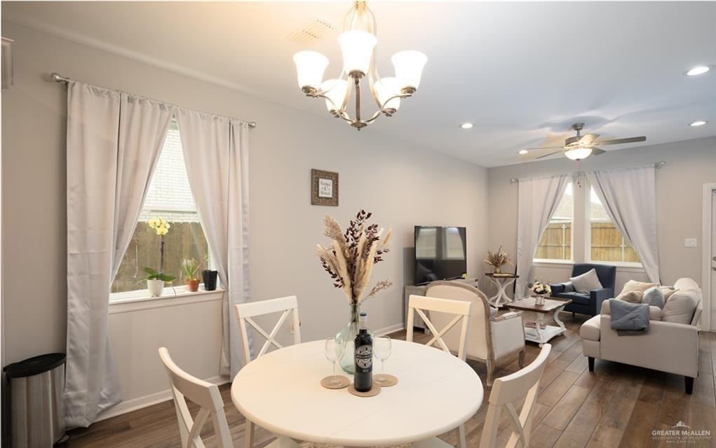 14117 Boykin Creek Road McAllen, TX 78504 - Photo 7 of 19 a living room with furniture a window and a chandelier