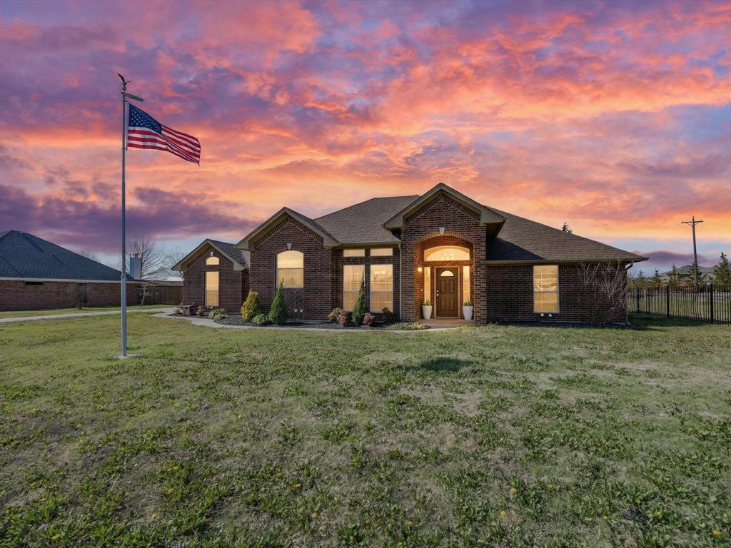 French country inspired facade with brick siding