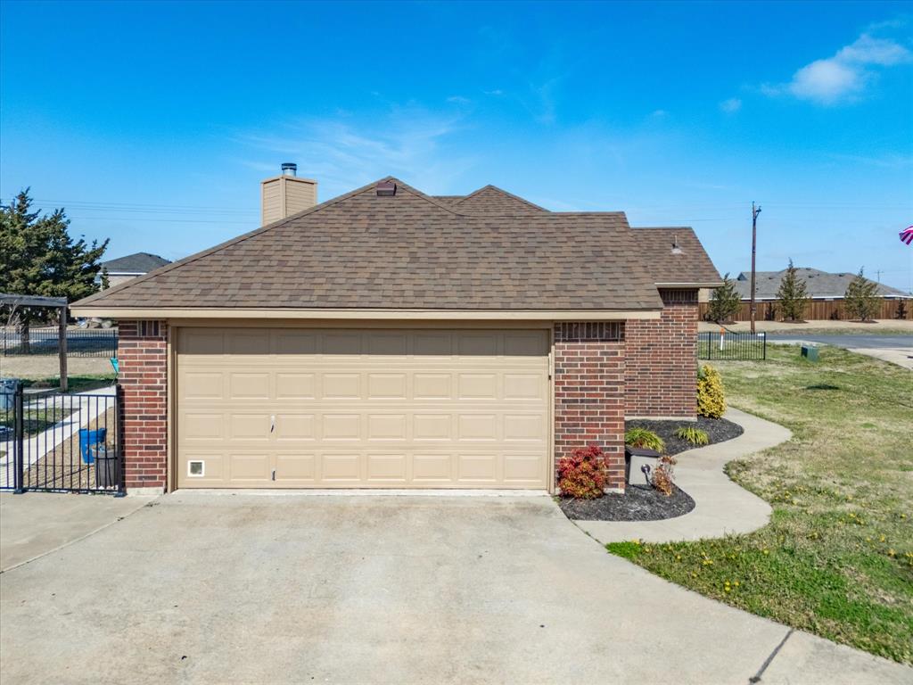 10000 Fireside Lane Forney, TX 75126 - Photo 11 of 40 View of property exterior with brick siding, a shingled roof, and concrete driveway