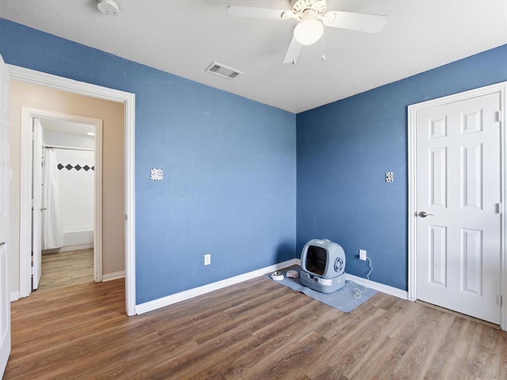 10000 Fireside Lane Forney, TX 75126 - Photo 13 of 40 Unfurnished bedroom featuring wood finished floors and a ceiling fan