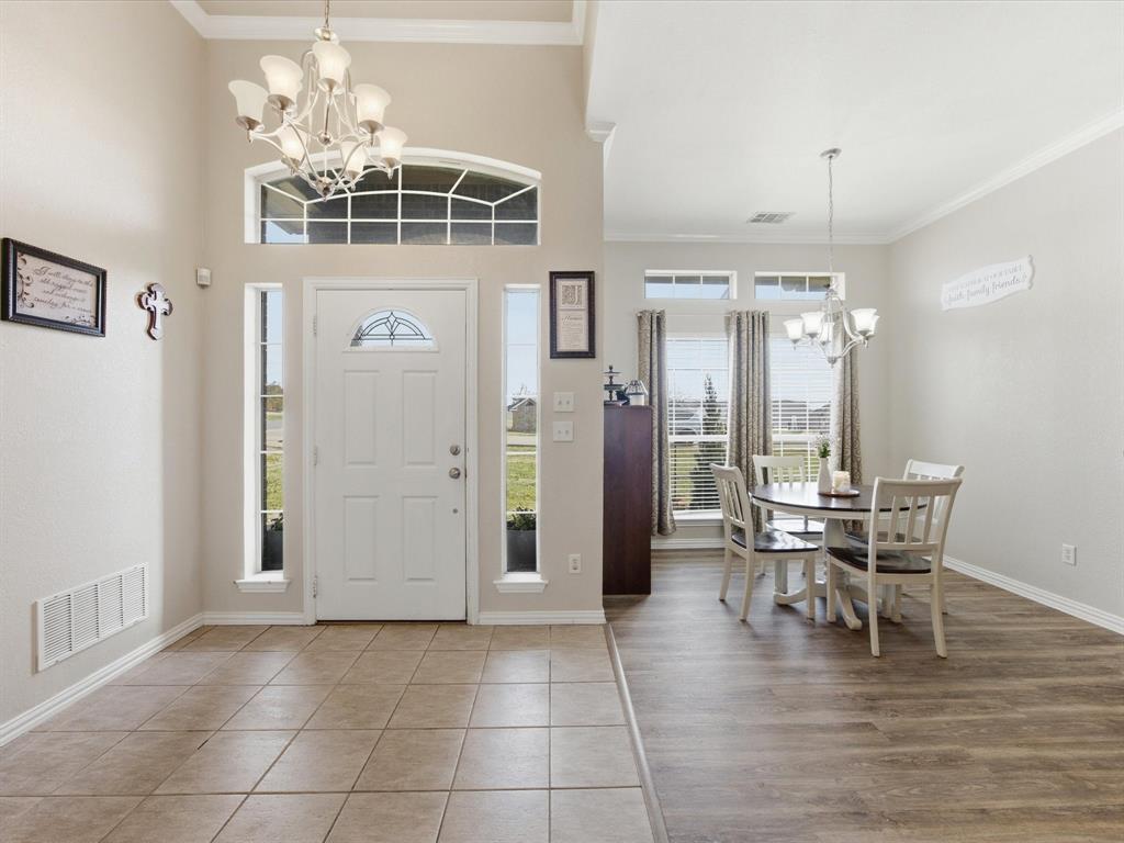10000 Fireside Lane Forney, TX 75126 - Photo 18 of 40 Entryway with suspended lighting, ornamental molding, and light tile patterned floors