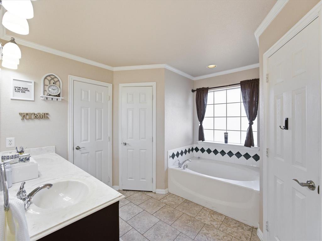 10000 Fireside Lane Forney, TX 75126 - Photo 27 of 40 Master bath with double vanity, a bath, ornamental molding, and light tile patterned floors